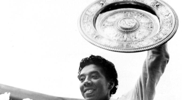 Althea Gibson smiles as she holds her trophies she won by capturing the National women's singles tennis championship at the West Side Tennis Club in Forest Hills, N.Y. Althea Gibson smiles as she holds her trophies she won by capturing the National women's singles tennis championship at the West Side Tennis Club in Forest Hills, N.Y.
