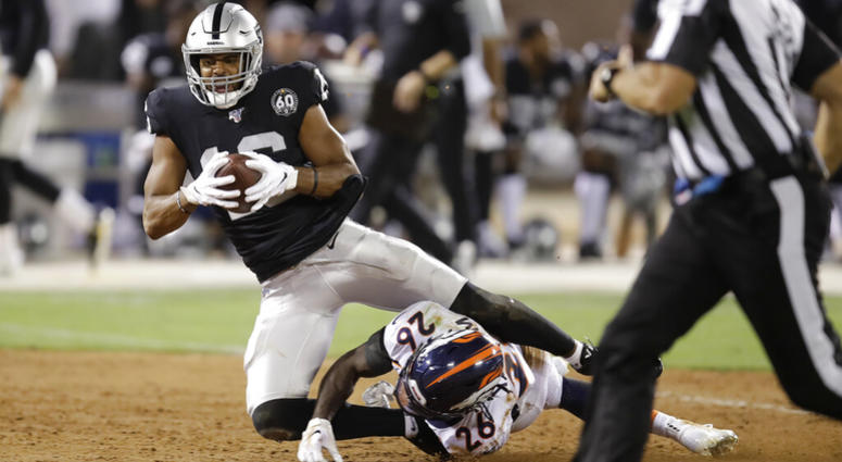 In this Sept. 9, 2019, file photo, Oakland Raiders wide receiver Tyrell Williams tumbles over Denver Broncos cornerback Isaac Yiadom (26) after making a reception during the first half of an NFL football game in Oakland, Calif. AP DO NOT USE