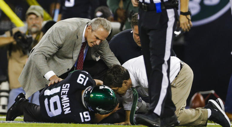 Trainers check on New York Jets quarterback Trevor Siemian (19) after he was injured during the first half of an NFL football game against the Cleveland Browns, Monday, Sept. 16, 2019, in East Rutherford, N.J. AP DO NOT USE