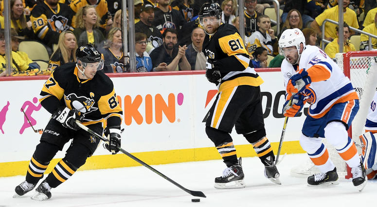 Sidney Crosby #87 of the Pittsburgh Penguins controls the puck against Cal Clutterbuck #15 of the New York Islanders Sidney Crosby #87 of the Pittsburgh Penguins controls the puck against Cal Clutterbuck #15 of the New York Islanders