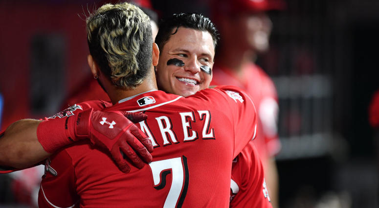 Derek Dietrich #22 of the Cincinnati Reds celebrates in the dugout with Eugenio Suarez #7 of the Cincinnati Reds after hitting a home run in the seventh inning against the Pittsburgh Pirates at Great American Ball Park on May 27, 2019 in Cincinnati, Ohio.