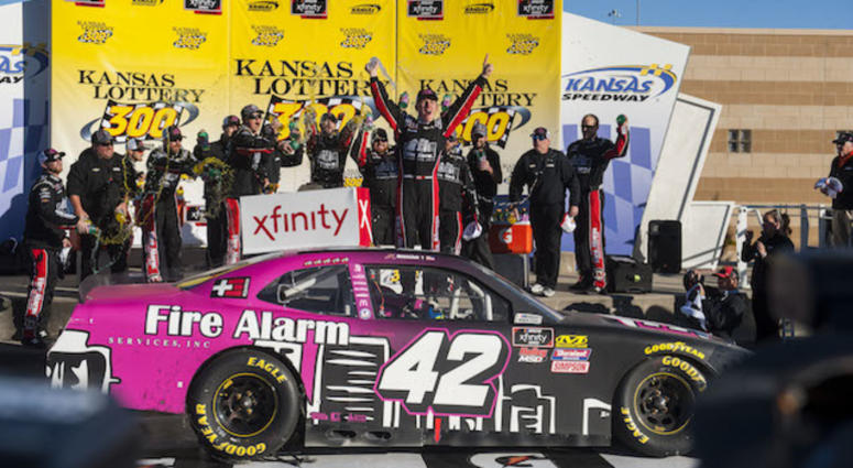 NASCAR Xfinity Series Driver John Hunter Nemechek Celebrates First Xfinity Series Win In The Kansas Lotter 300 Atop No. 42 Fire Alarm Services Chip Ganassi Racing Camaro John Hunter Nemechek Gets First Xfinity Series Win At Kansas Speedway In No. 42 Chip Ganassi Racing Chevrolet Camaro