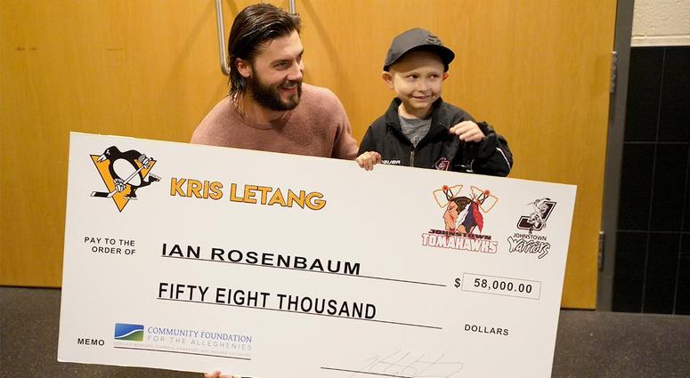 Kris Letang presenting a check to Ian Rosenbaum