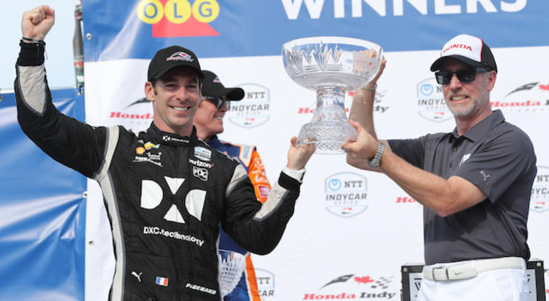 Simon Pagenaud Receives Trophy For Winning The Honda Indy Toronto Simon Pagenaud Receives Trophy In Victory Lane At Toronto