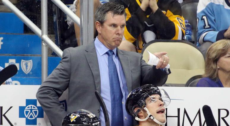 Pittsburgh Penguins head coach Mike Sullivan (top) gestures on the bench against the Montreal Canadiens during the second period at PPG PAINTS Arena. Montreal won 5-1.