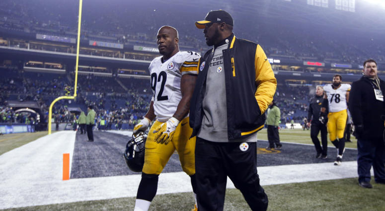 Pittsburgh Steelers outside linebacker James Harrison (92) and head coach Mike Tomlin walk off the field following a 39-30 loss against the Seattle Seahawks at CenturyLink Field.