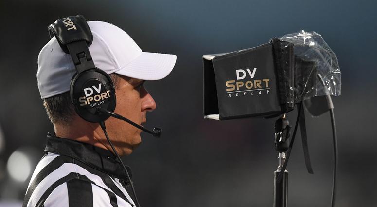 referee watches an instant replay during a game