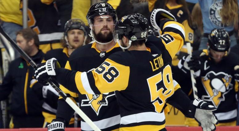 defenseman Kris Letang (58) celebrates with defenseman Brian Dumoulin