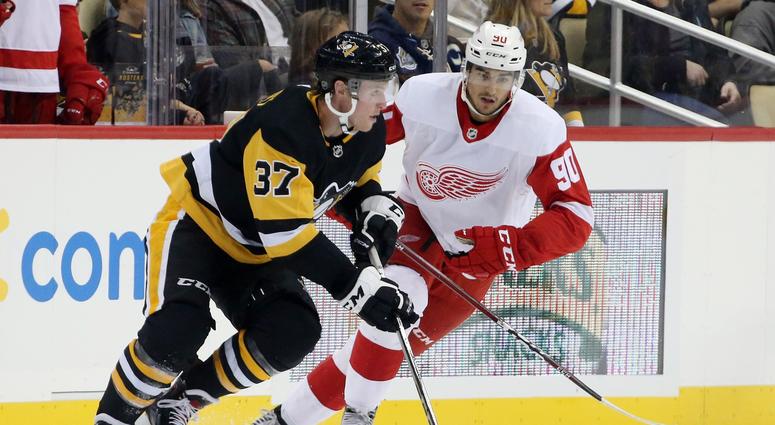 Pittsburgh, PA, USA; Pittsburgh Penguins forward sam Lafferty (37) moves the puck against Detroit Red Wings forward Joe Veleno (90) during the third period at PPG PAINTS Arena.