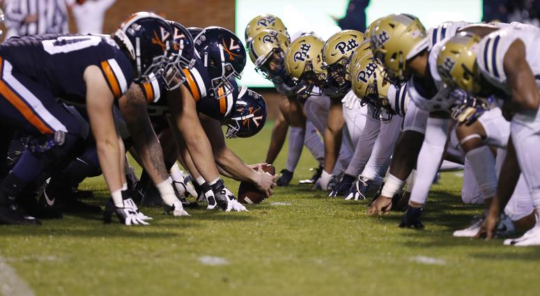 The Virginia Cavaliers offense lines up against the Pittsburgh Panthers defense in the first quarter at Scott Stadium. The Virginia Cavaliers offense lines up against the Pittsburgh Panthers defense in the first quarter at Scott Stadium.