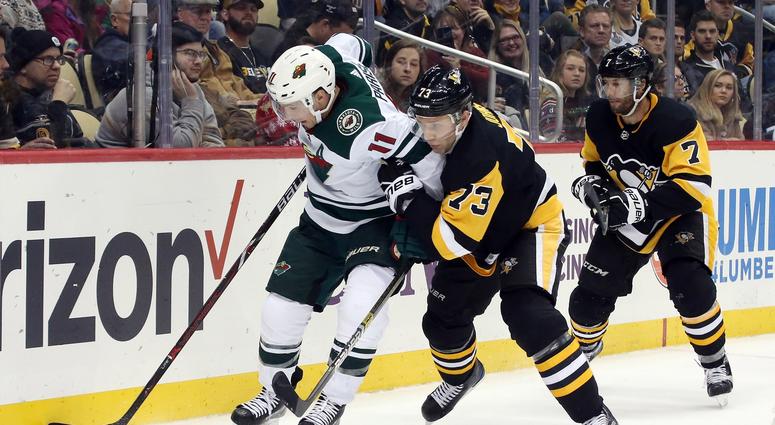 USA; Minnesota Wild left wing Zach Parise (11) moves the puck against Pittsburgh Penguins defenseman Jack Johnson (73)