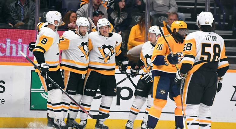 Bryan Rust (17) celebrates with teammates after scoring during the second period