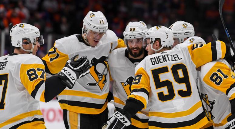 Pittsburgh Penguins defenseman Justin Schultz (4) celebrates his goal with the teammates Pittsburgh Penguins defenseman Justin Schultz (4) celebrates his goal with the teammates