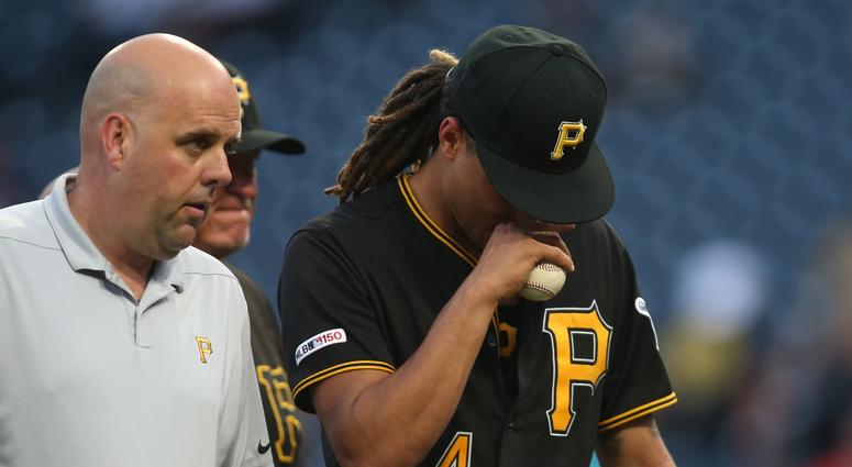 Pittsburgh, PA, USA; Pittsburgh Pirates starting pitcher Chris Archer (24) reacts as he leaves the field with with Pirates trainer Bryan Housand