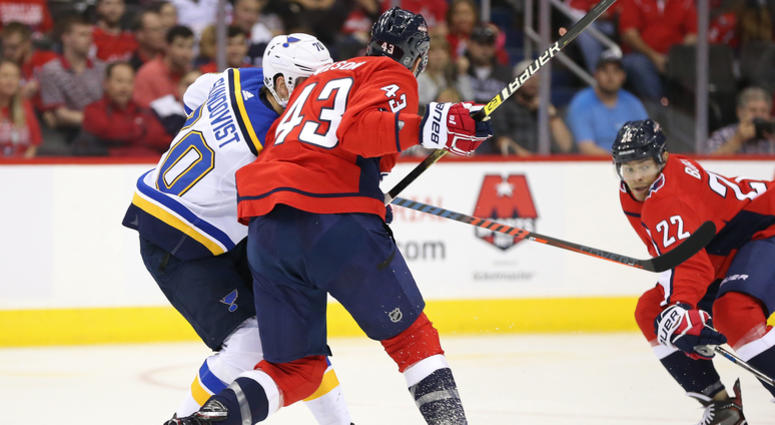 Washington Capitals right wing Tom Wilson (43) checks St. Louis Blues center Oskar Sundqvist (70) in the second period at Capital One Arena.