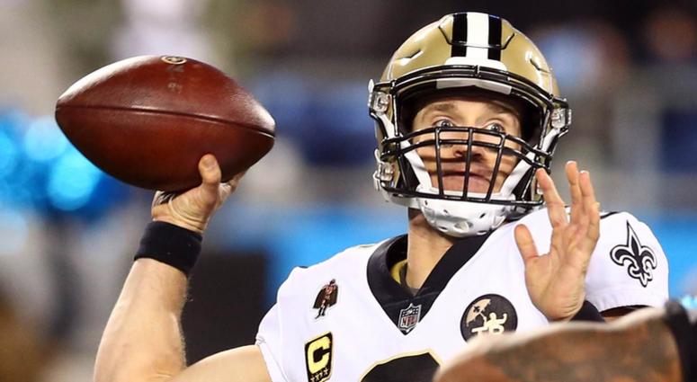 New Orleans Saints quarterback Drew Brees (9) looks to pass while under pressure by Carolina Panthers defensive end Julius Peppers (90) in the third quarter at Bank of America Stadium.