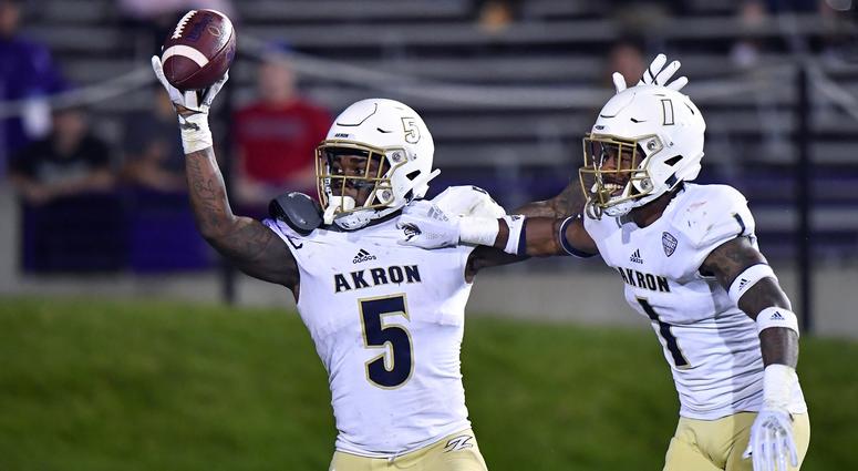 Akron Zips linebacker Ulysees Gilbert III (5) react after scoring a touchdown on a fumble recovery in the second half against the Northwestern Wildcats at Ryan Field.