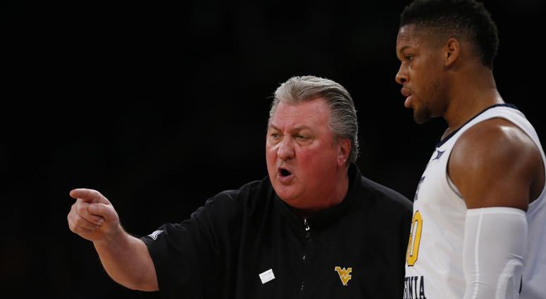 West Virginia Mountaineers head coach Bob Huggins talks to forward Sagaba Konate (50) during the second half against the Florida Gators at Madison Square Garden.