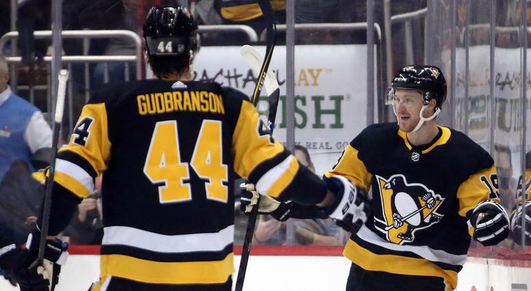 Pittsburgh Penguins center Jared McCann (19) reacts after scoring a goal with Pittsburgh Penguins defenseman Erik Gudbranson (44) against the Boston Bruins during the first period at PPG PAINTS Arena.