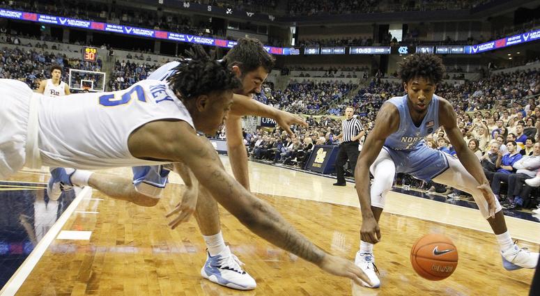 Pittsburgh Panthers guard Au'Diese Toney (5) dives for a loose ball against North Carolina Tar Heels forward Luke Maye (32) and guard Leaky Black (1) during the second half at the Petersen Events Center