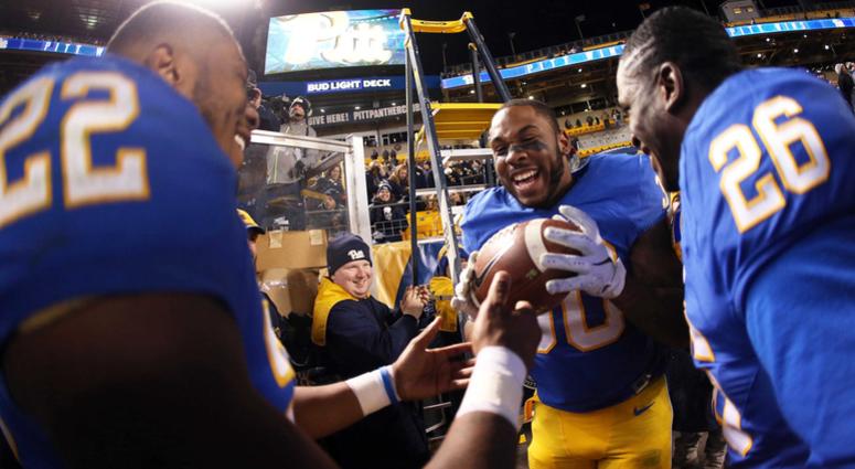Pittsburgh Panthers running back Darrin Hall (22) hands the game ball to running back Qadree Ollison (30) after the Panthers defeated the Virginia Tech Hokies at Heinz Field. Pittsburgh won 52-22.