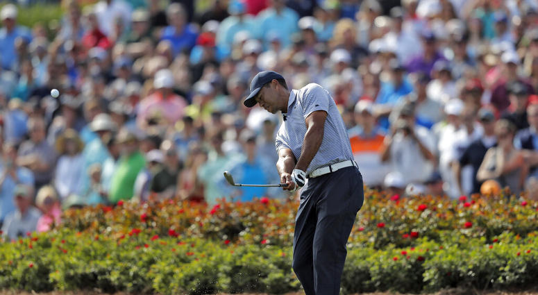Tiger Woods hits from the drop zone after hitting his tee shot into the water on the 17th hole during the second round of The Players Championship golf tournament Friday, March 15, 2019, in Ponte Vedra Beach, Fla Tiger Woods hits from the drop zone after hitting his tee shot into the water on the 17th hole during the second round of The Players Championship golf tournament Friday, March 15, 2019, in Ponte Vedra Beach, Fla