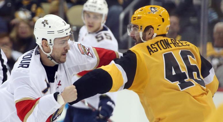 Pittsburgh Penguins center Zach Aston-Reese (46) and Florida Panthers center Colton Sceviour (7) fight during the third period at PPG PAINTS Arena. The Penguins won 5-1.