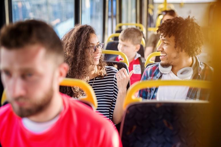 two people talking on a bus