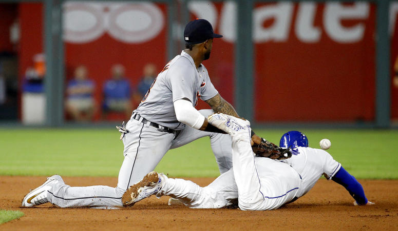 Kansas City Royals' Alex Gordon beats the tag by Detroit Tigers second baseman Niko Goodrum to steal second during the seventh inning