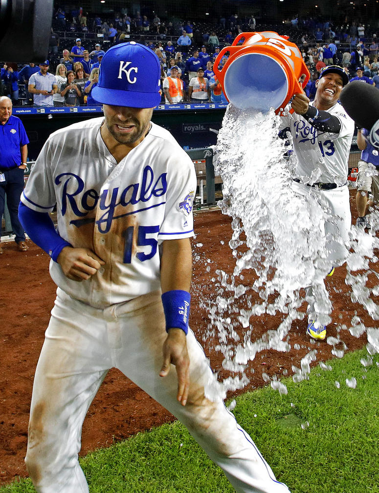 Kansas City Royals' Whit Merrifield (15) is doused by Salvador Perez (13) after their baseball game against the Chicago White Sox