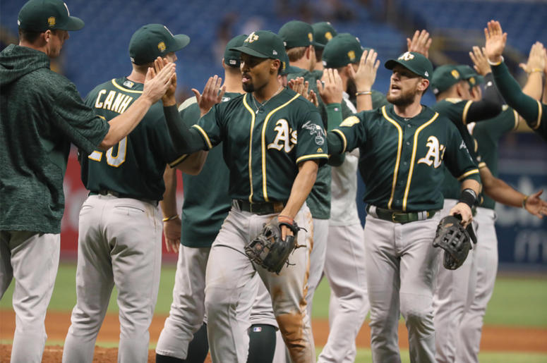 Oakland Athletics Sep 14, 2018; St. Petersburg, FL, USA; Oakland Athletics shortstop Marcus Semien (10) and Oakland Athletics second baseman Jed Lowrie (8) congratulate each other as they beat the Tampa Bay Rays at Tropicana Field. Mandatory Credit: Kim Klement-USA TODAY S