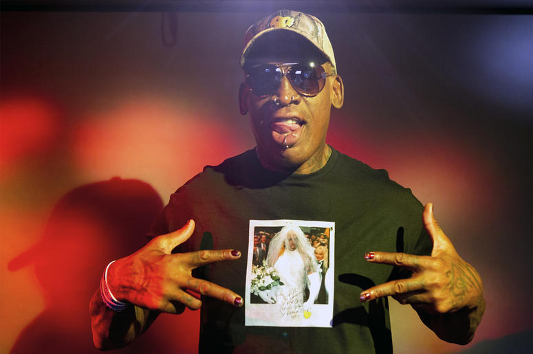 AP19253410851019 In this Monday, Sept. 9, 2019, photo, former NBA star Dennis Rodman poses wearing a T-shirt depicting himself in a wedding dress at a 1996 book promo event, in Los Angeles. (AP Photo/Damian Dovarganes)