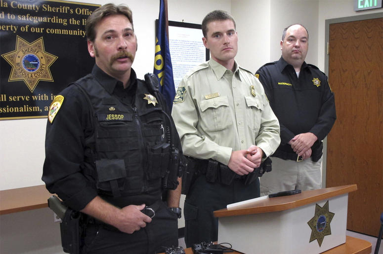 AP18191757553982 From left, Missoula County Sheriff's Deputy Ross Jessop, U.S. Forest Service Law Enforcement Officer Nick Scholz and Sheriff T.J. McDermott answer questions on Tuesday, July 10, 2018, in Missoula, Mont., about a baby found in the woods at least nine hours