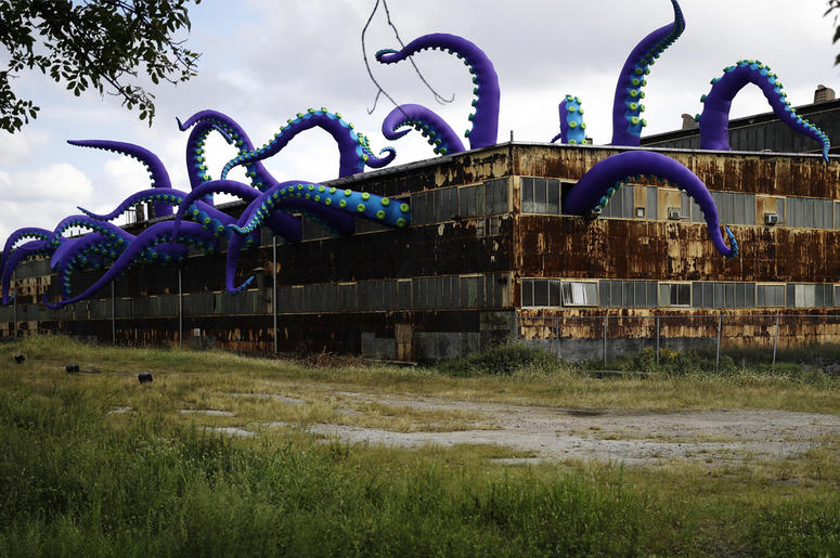 AP18282677626898 An inflatable sculpture entitled "Sea Monsters HERE" extends from a rusting warehouse called Building 61 at the Navy Yard in Philadelphia, Tuesday, Oct. 9, 2018. The installation was created by UK-based artists Filthy Luker and Pedro Estrellas. The former