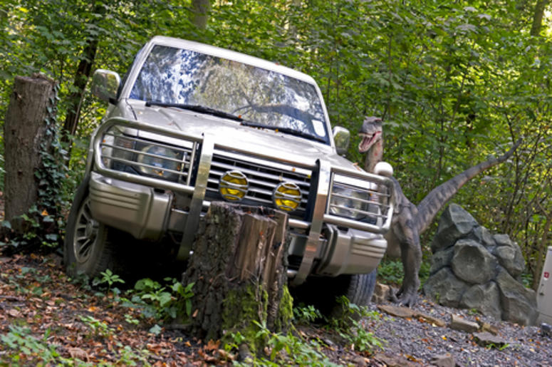 Dinosaur and a broken down car Dinosaur and a broken down car