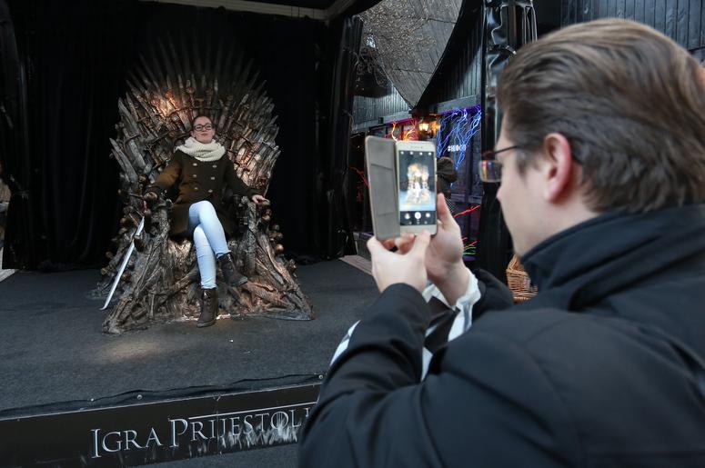 taking a photo with the iron throne