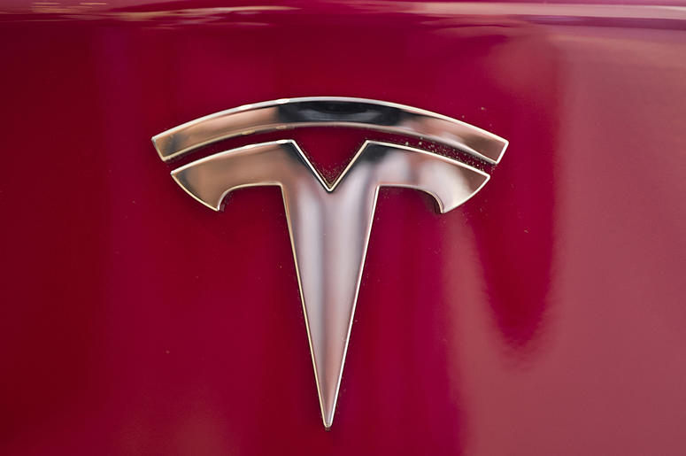 AP18338180922564 This Wednesday, Aug. 8, 2018, file photo shows the Tesla emblem on the back end of a Model S in the Tesla showroom in Santa Monica, Calif. The California Highway Patrol says it may have used the Autopilot system of a Tesla Model S to stop the car after it