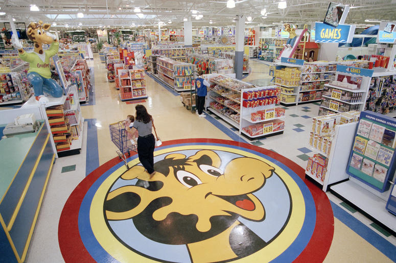 AP19042716104049 In this July 30, 1996, file photo, a woman pushes a shopping cart over a graphic of Toys R Us mascot Geoffrey the giraffe at the Toys R Us store in Raritan, N.J. Richard Barry, a former Toys R Us executive and now CEO of the new company called Tru Kids In