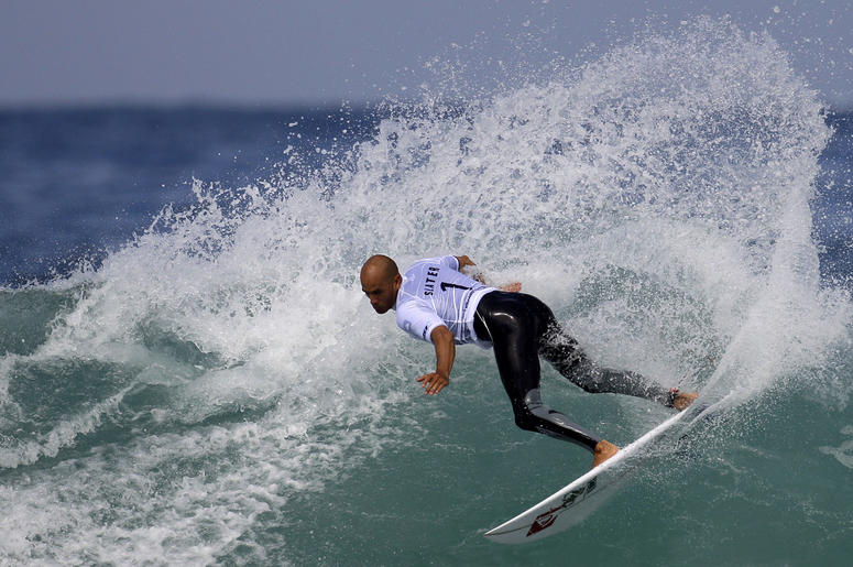 AP19072828567017 In this May 17, 2011, file photo, Kelly Slater competes in the first round of the Billabong Rio Pro surfing competition at the Arpoador Beach in Rio de Janeiro. (AP Photo/Felipe Dana, File)