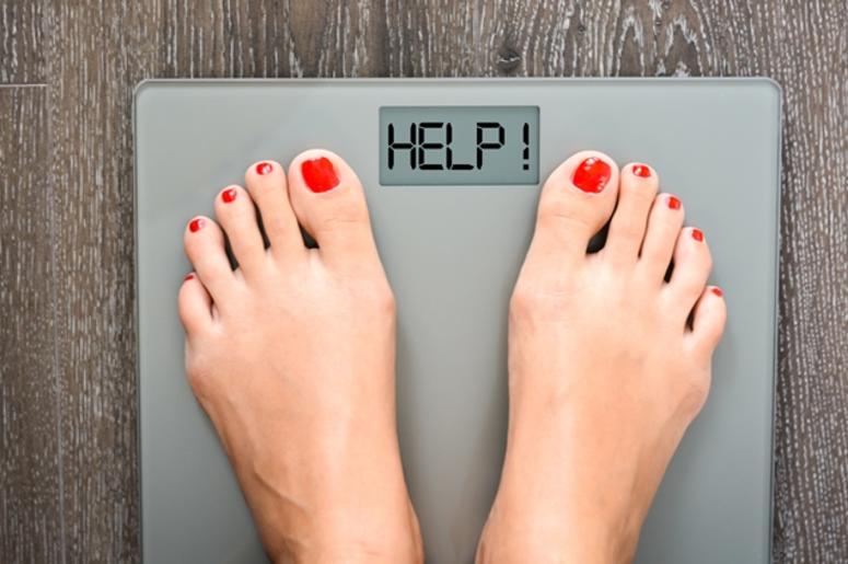 Lose weight concept with person on a scale measuring kilograms Lose weight concept with person on a scale measuring kilograms