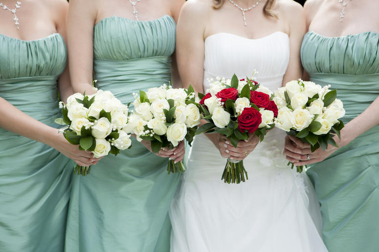 (Daisy-Daisy/ iStock/ Getty Images Plus) Bride and bridesmaids holding bouquets