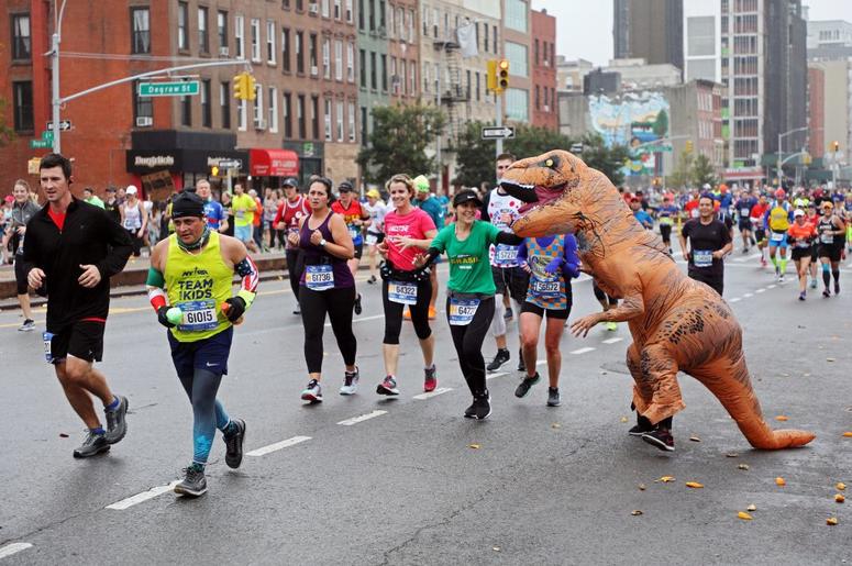 (Michael Heiman/ Getty Images) Inflatable T-Rex costume runs in race