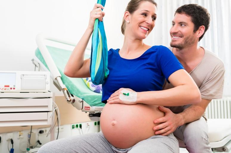 Pregnant woman and man in delivery room of hospital Pregnant woman and man in delivery room of hospital