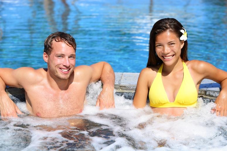 Hot tub - Couple in spa wellness jacuzzi Hot tub - Couple in spa wellness jacuzzi