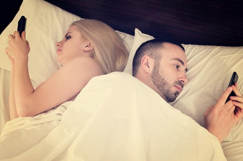 Couple socializing with mobile phones in bed Couple socializing with mobile phones in bed