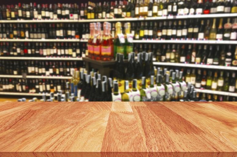 Wood table and wine Liquor bottle on shelf blurred background. Label, display. Wood table and wine Liquor bottle on shelf blurred background. Label, display.