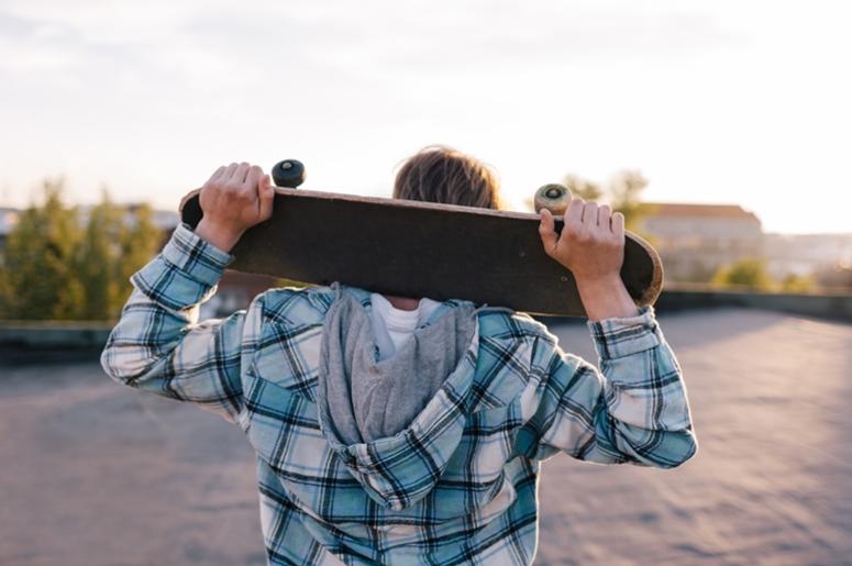 Street subculture. Skateboarder with skateboard Street subculture. Skateboarder with skateboard
