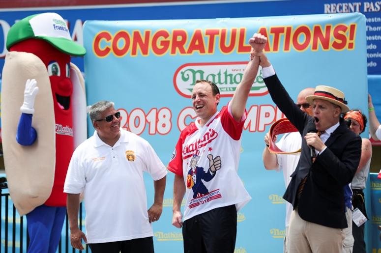 Joey Chestnut (L) celebrates victory after winning men's division competition at the Nathan’s Hot Dog Eating Contest at Coney Island of New York, the United States, July 4, 2018. American man Joey Chestnut set a new world record Wednesday by devouring 74 Joey Chestnut (L) celebrates victory after winning men's division competition at the Nathan’s Hot Dog Eating Contest at Coney Island of New York, the United States, July 4, 2018. American man Joey Chestnut set a new world record Wednesday by devouring 74