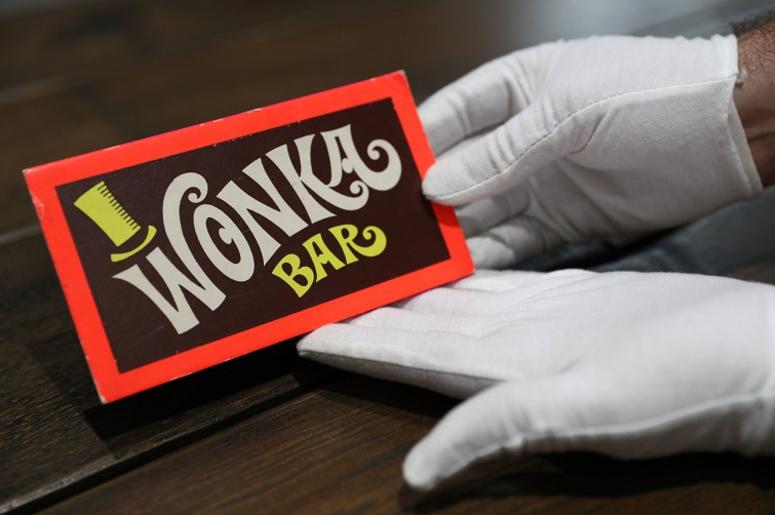 A Prop Store employee holds a Wonka Bar from the film Willy Wonka & the Chocolate Factory (estimate £8-10,000) in the Prop Store head office near Rickmansworth ahead of the Entertainment Memorabilia Live Auction on 20th September. A Prop Store employee holds a Wonka Bar from the film Willy Wonka & the Chocolate Factory (estimate £8-10,000) in the Prop Store head office near Rickmansworth ahead of the Entertainment Memorabilia Live Auction on 20th September.
