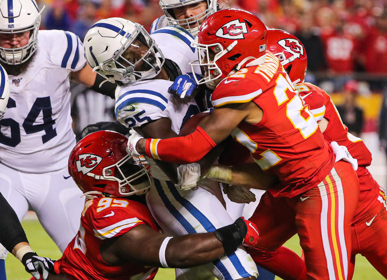 Jay Biggerstaff-USA TODAY Sports Oct 6, 2019; Kansas City, MO, USA; Indianapolis Colts running back Marlon Mack (25) is tackled by Kansas City Chiefs defensive tackle Khalen Saunders (99) and free safety Juan Thornhill (22) during the second half at Arrowhead Stadium. Mandatory Credit: J